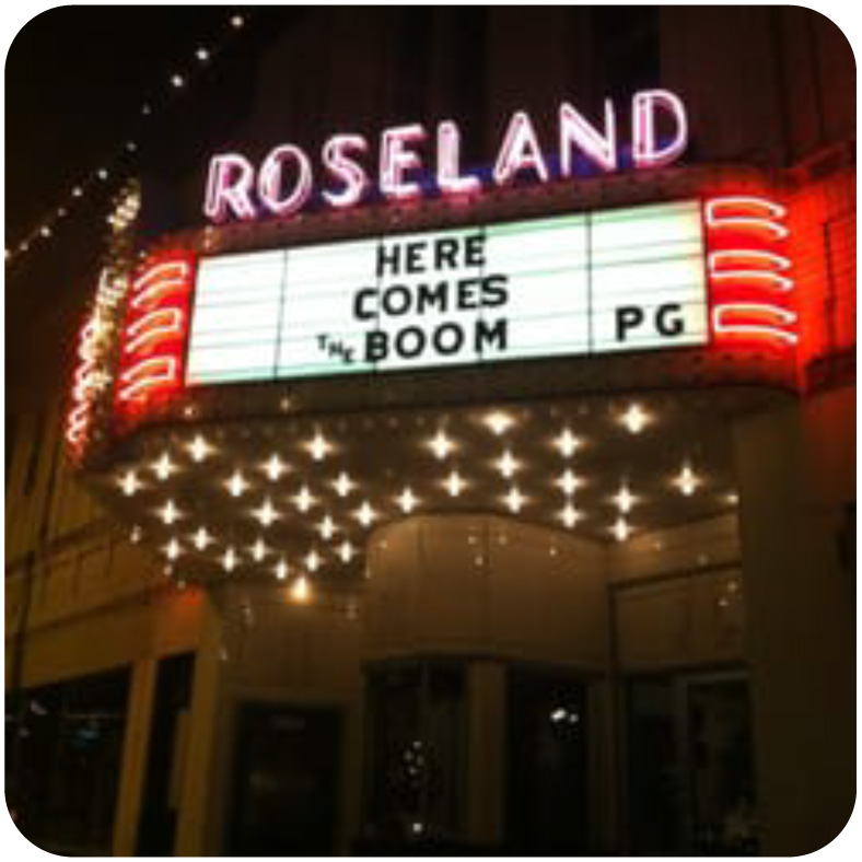 Highlighting the original pink neon marquee at the Roseland Theatre.
